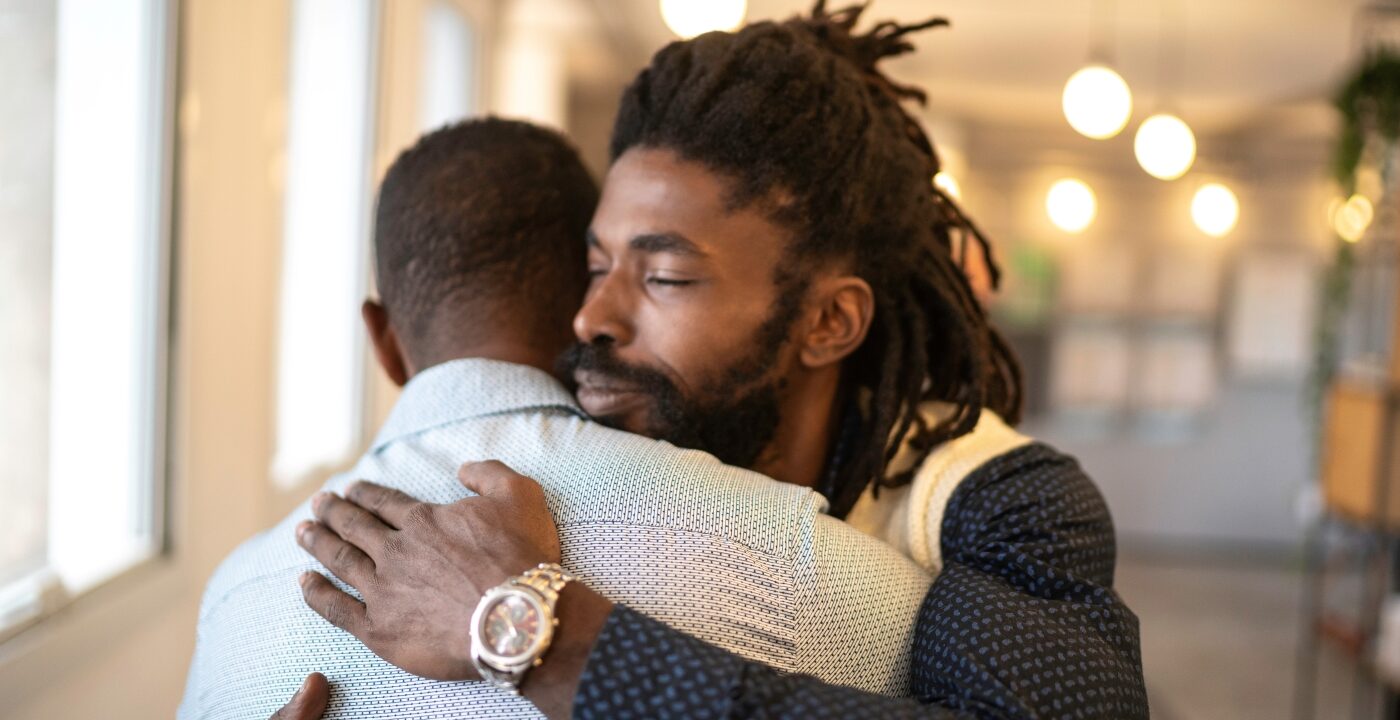 Two men hugging
