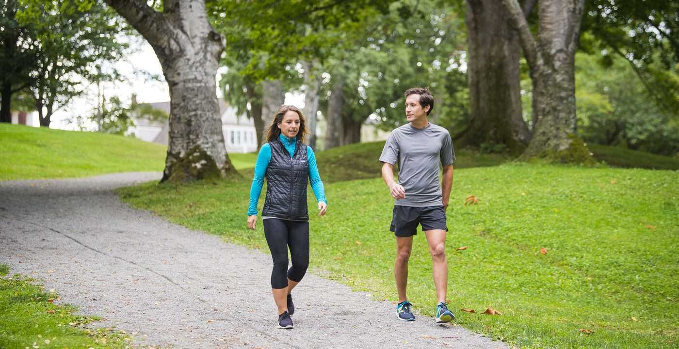 Man and woman walking a path
