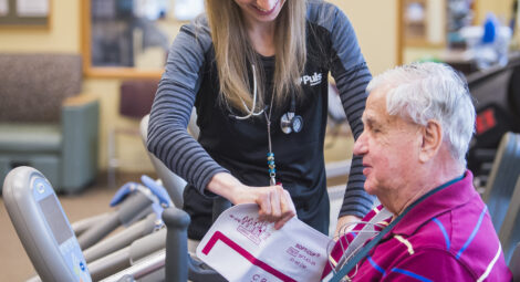 Older man doing exercises with health care professional