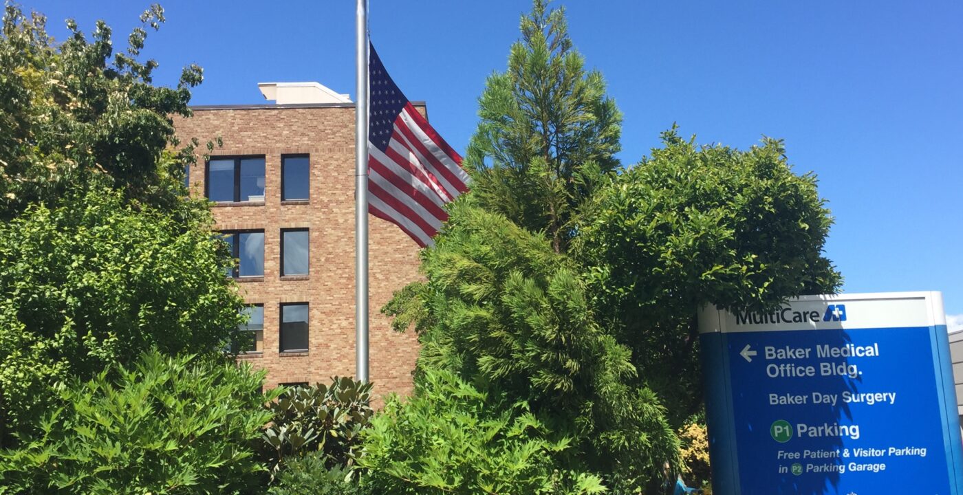 Flag half mast in front of a MultiCare building