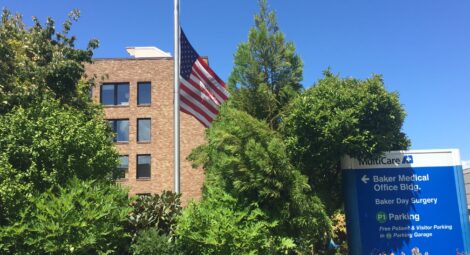 Flag half mast in front of a MultiCare building