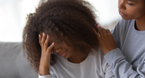 Mother comforting upset teen daughter