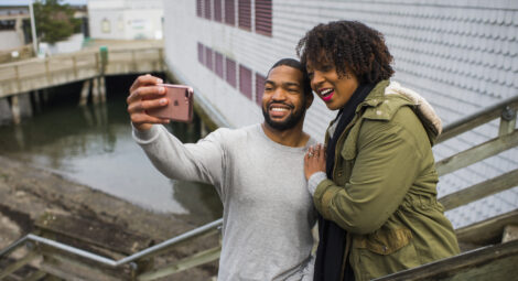 Man and woman smiling and taking a picture