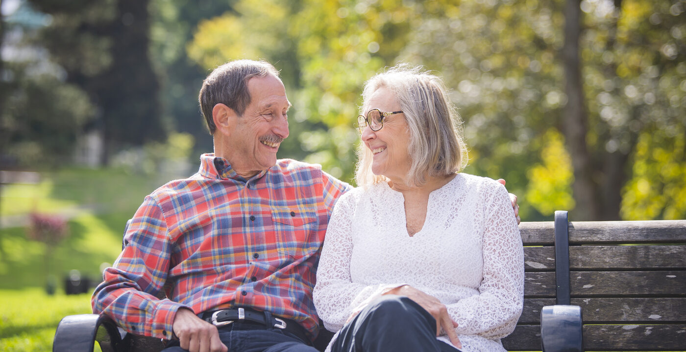 A man and woman sitting on a bench