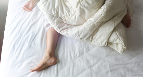 Woman sleeping in bed, feet showing