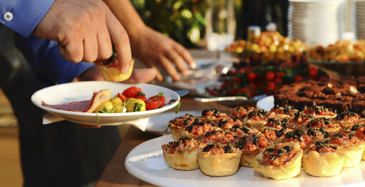 Person at a holiday party getting appetizers