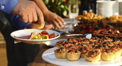 Person at a holiday party getting appetizers