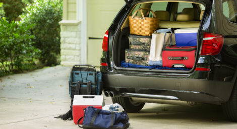 Family vehicle packed, ready for road trip, vacation outside home.