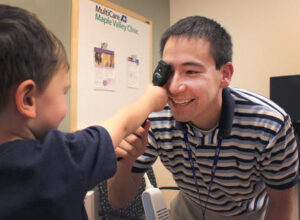 Male doctor interacting with a child patient