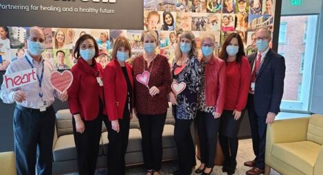 A group of leadership standing together wearing masks.