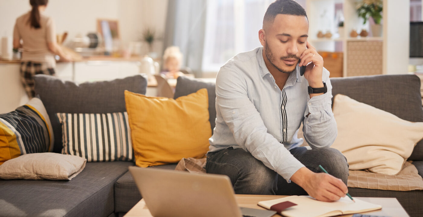 Male talking on the phone taking notes