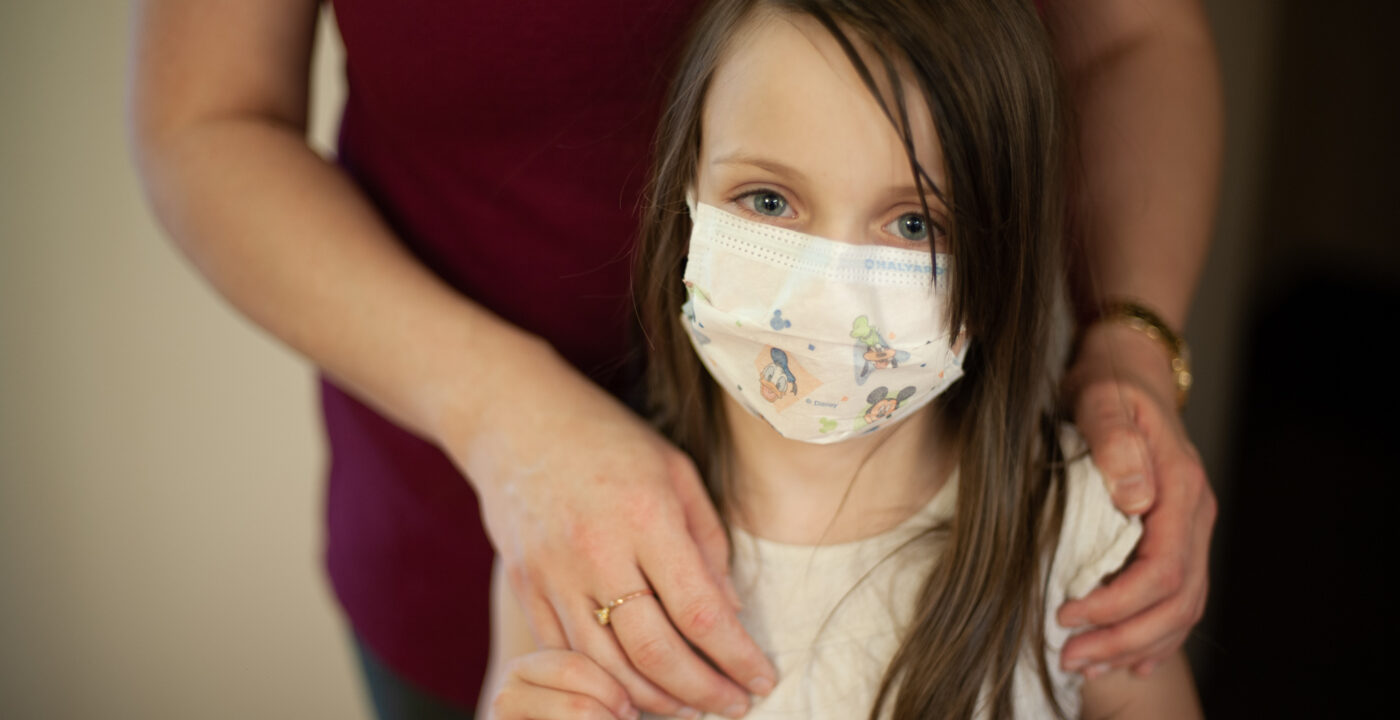 Girl wearing a mask looking at the camera