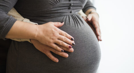 Pregnant woman holding belly