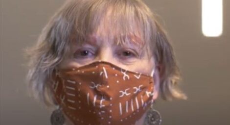Woman with a mask on looking at the camera