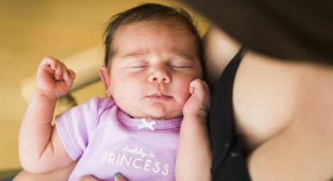 Mother holding sleeping baby