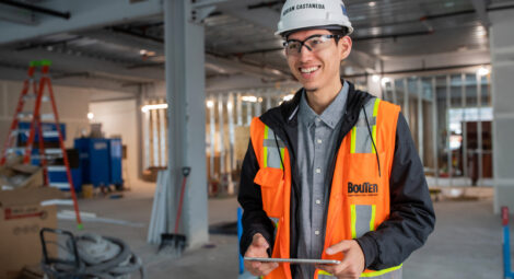 Safety worker in orange work vest and hardhat
