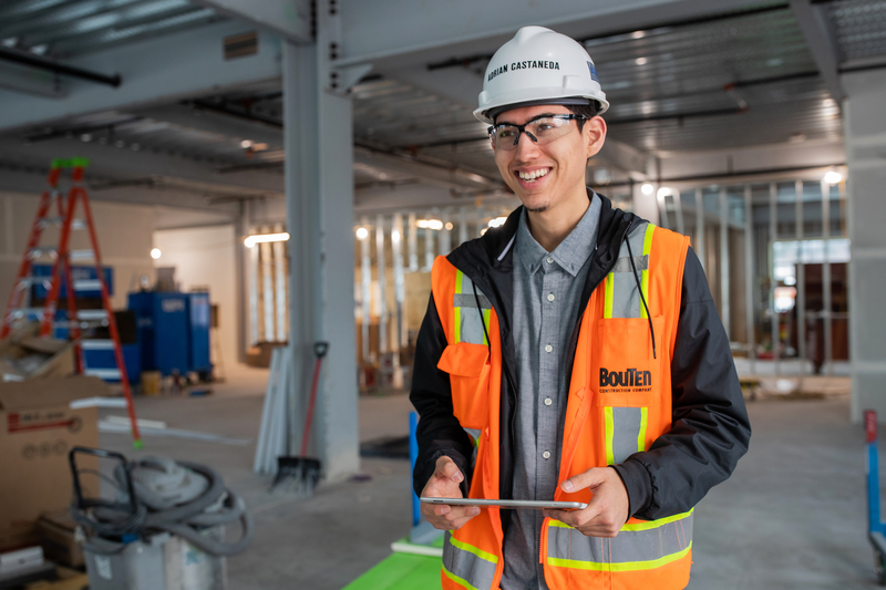 Safety worker in orange work vest and hardhat