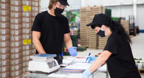 Two workers wearing masks and gloves