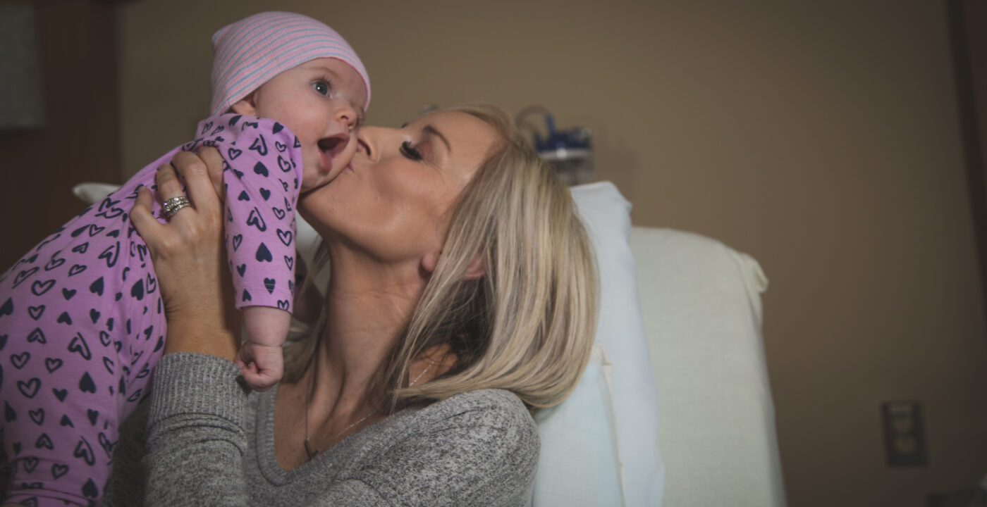 Mother kissing baby