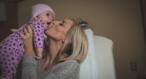 Mother kissing baby
