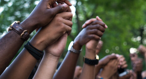 Hands raised in the hair holding other hands