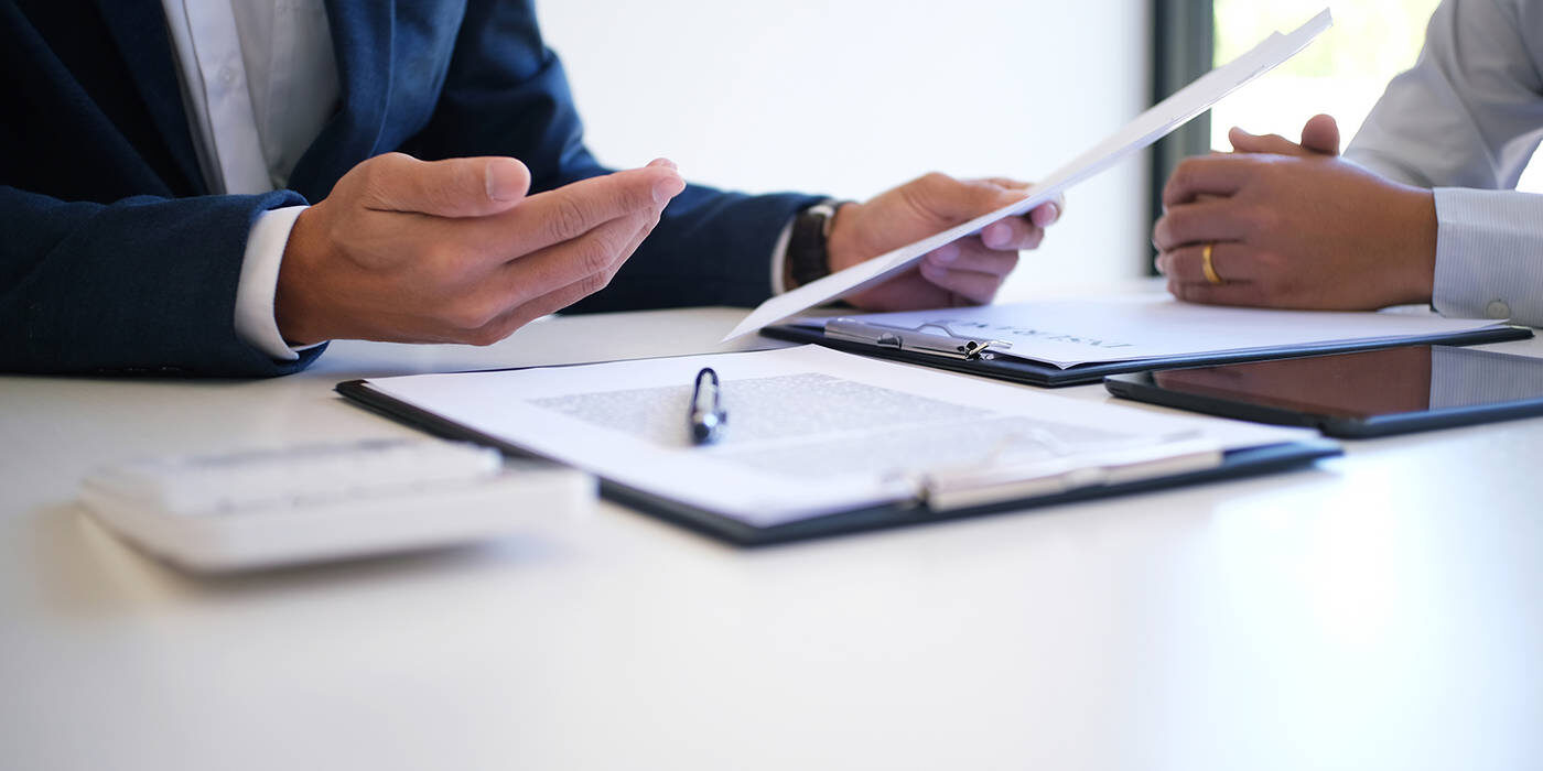 Stock image of man explaining documents