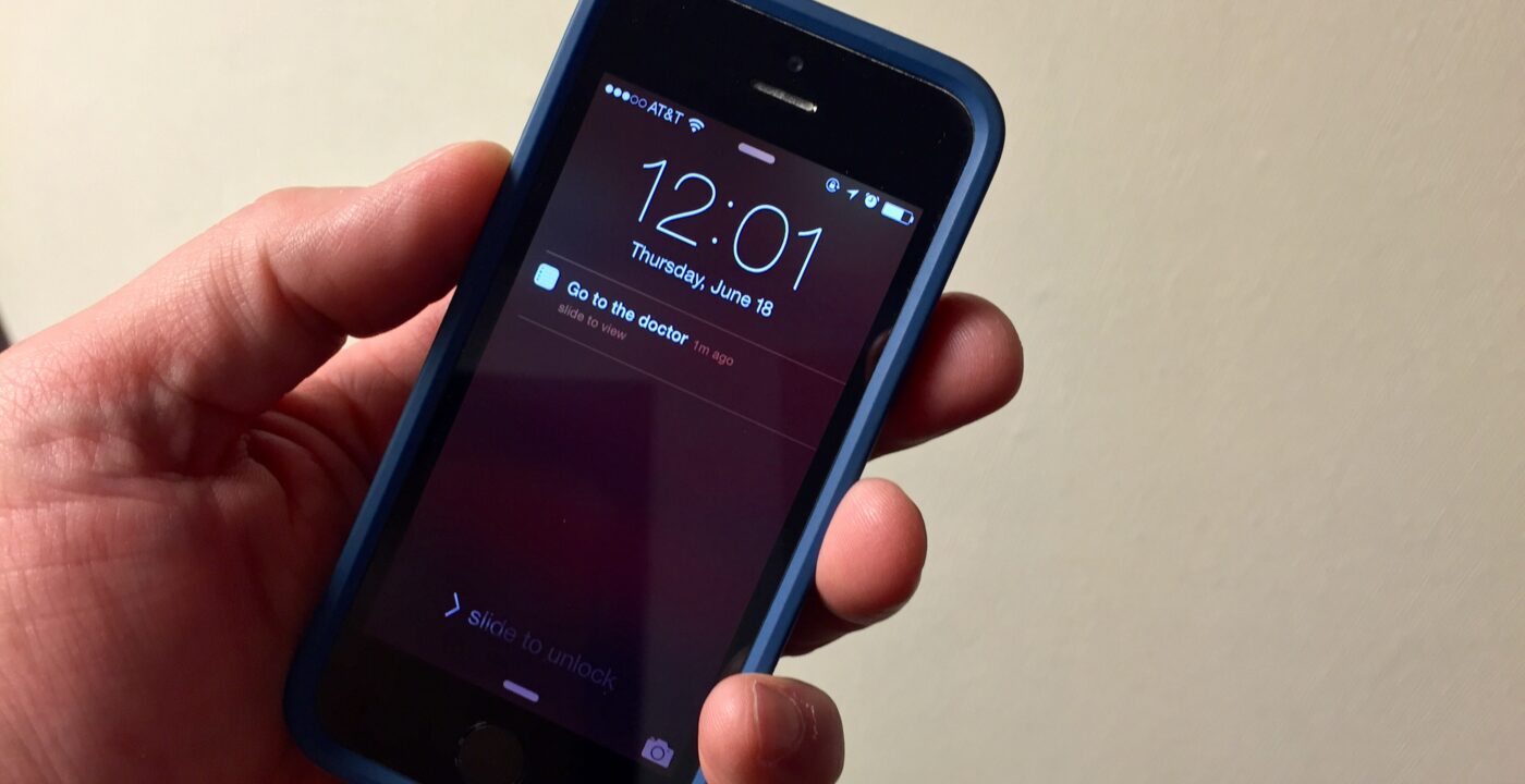 Mans hand holding phone