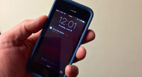 Mans hand holding phone