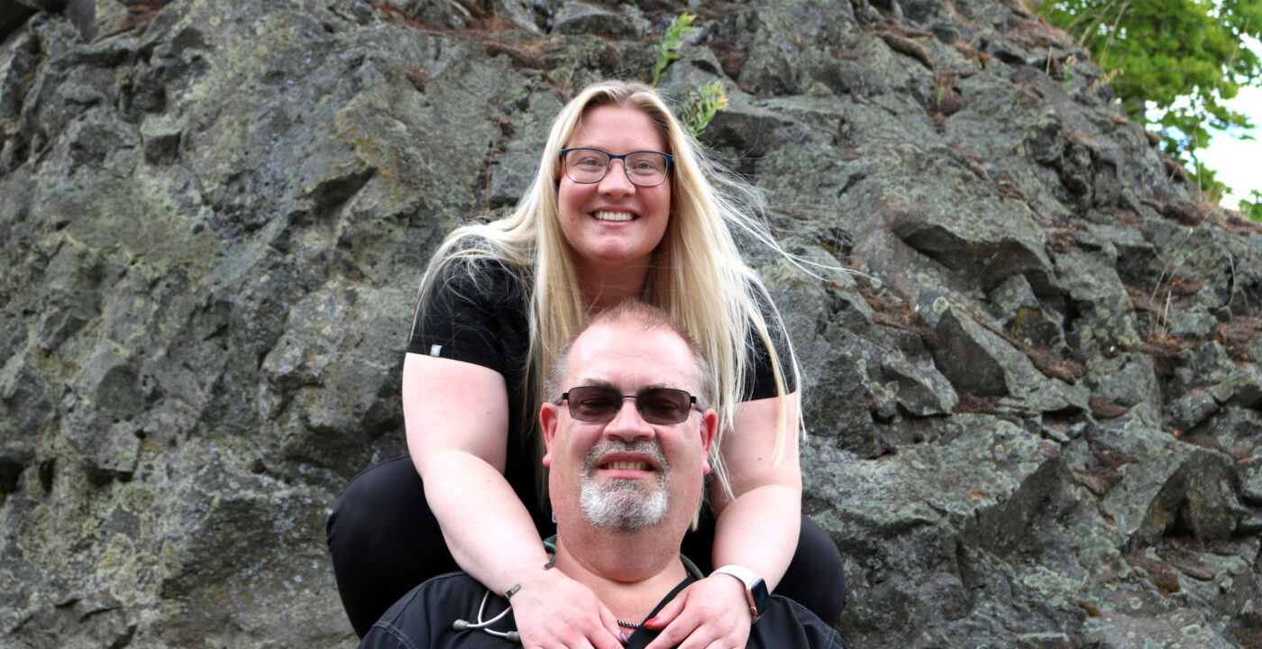 Father and daughter smiling at the camera