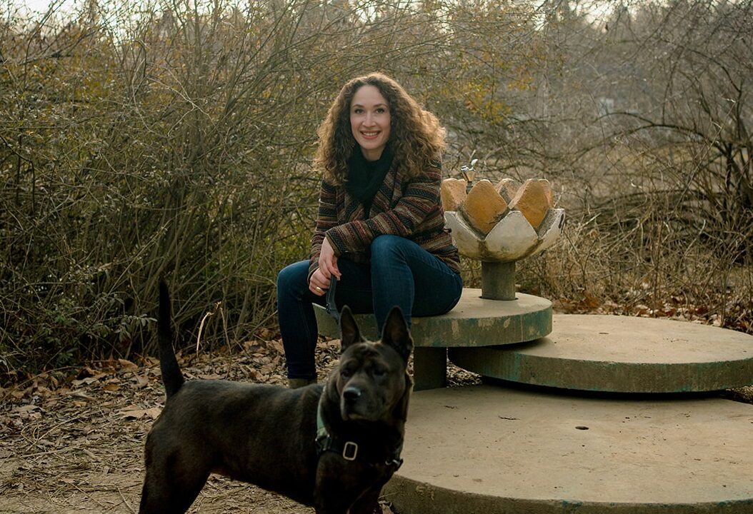 Woman sitting behind her dog