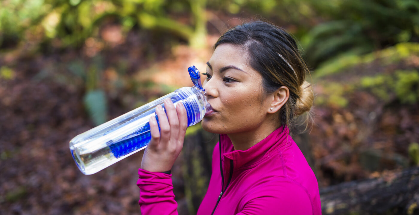 Woman drinking water outside
