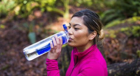 Woman drinking water outside