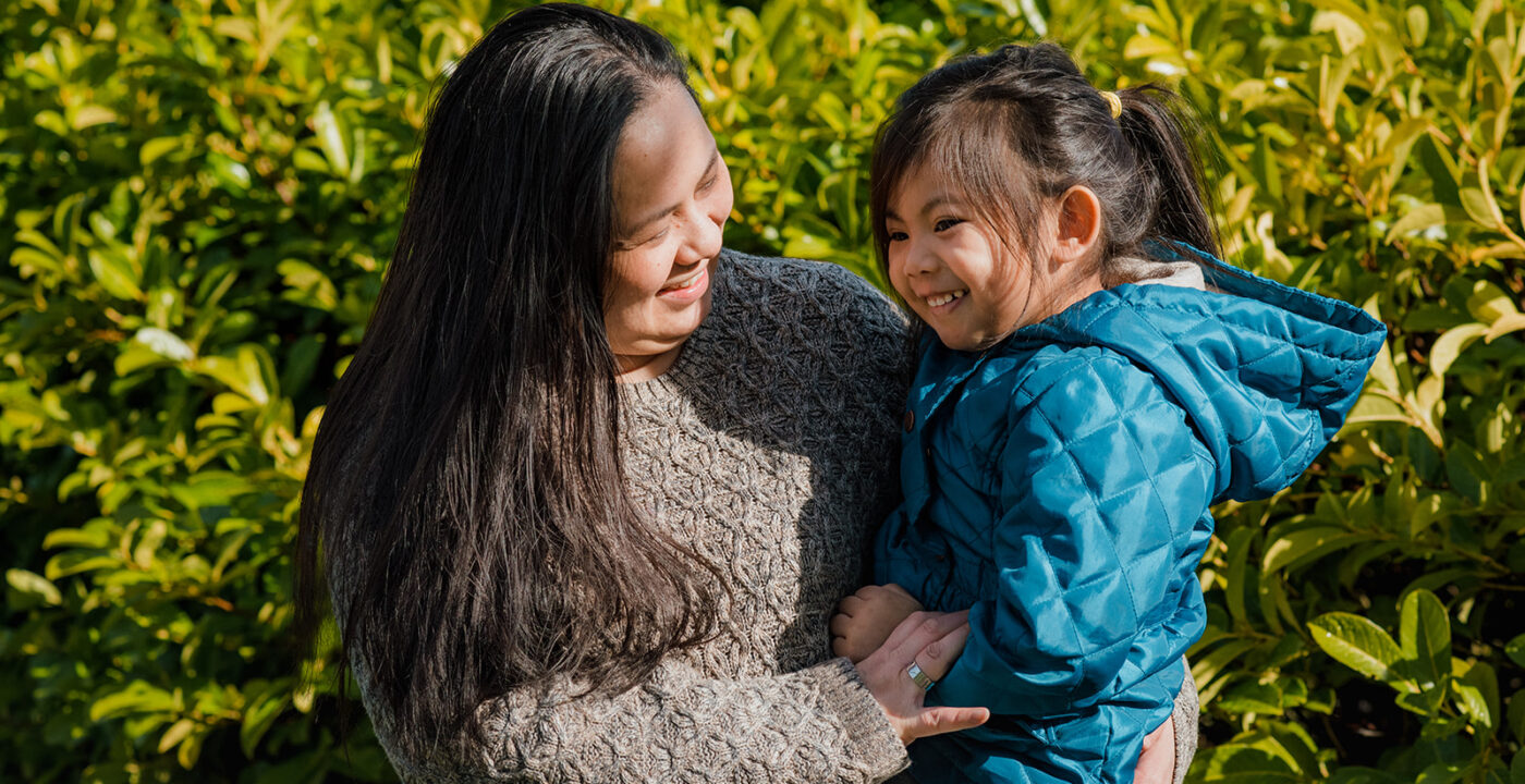 Mother holding daughter
