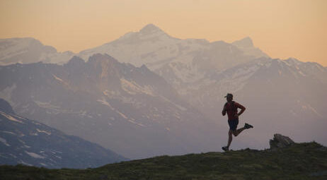 Person running in front of a mountain