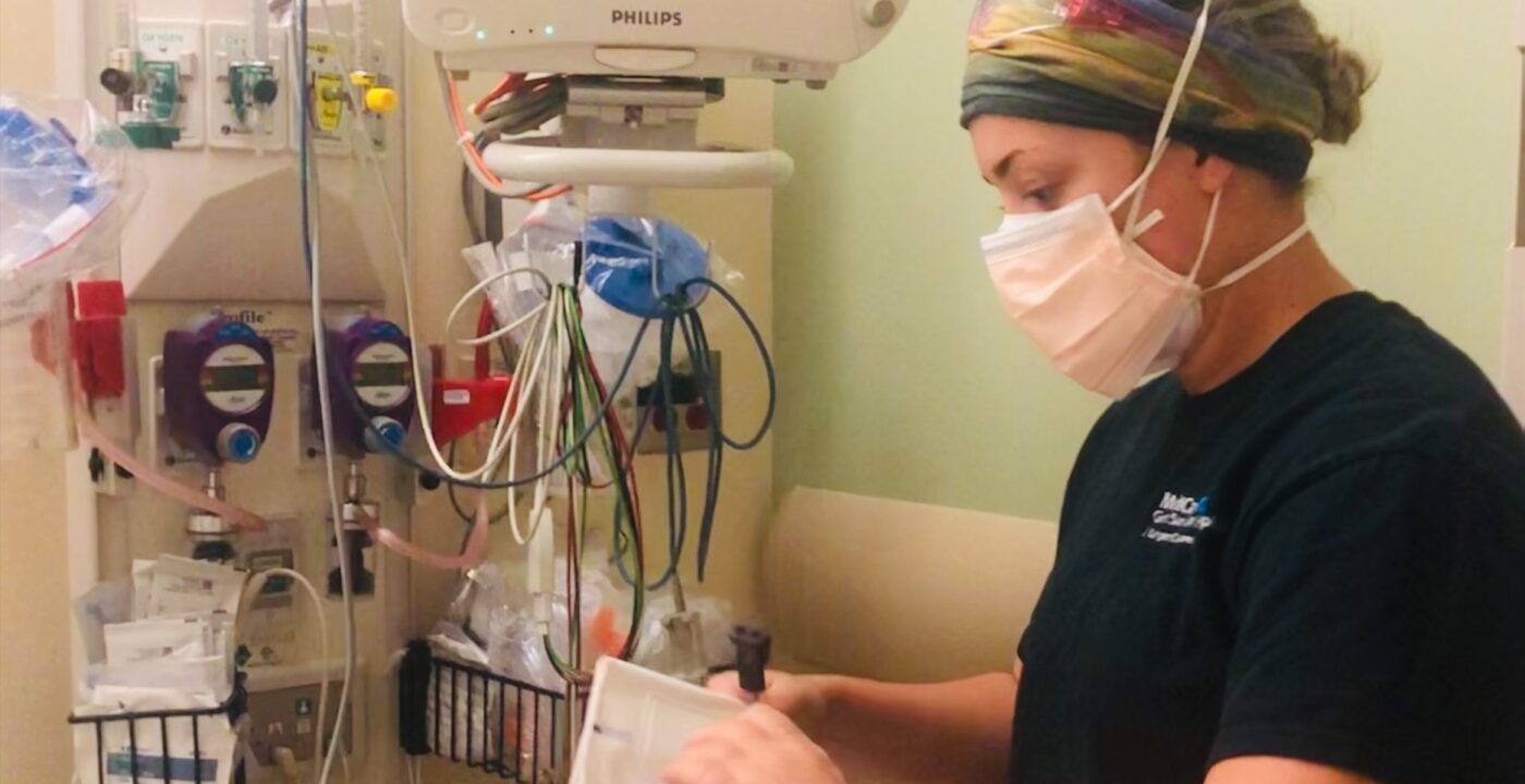 Health care working on medical equipment