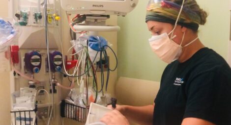 Health care working on medical equipment