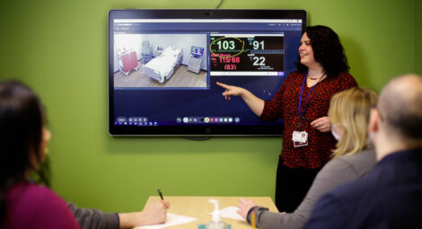 Woman pointing to a screen