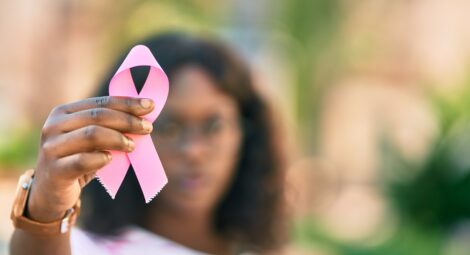 Woman holding a pink ribbon
