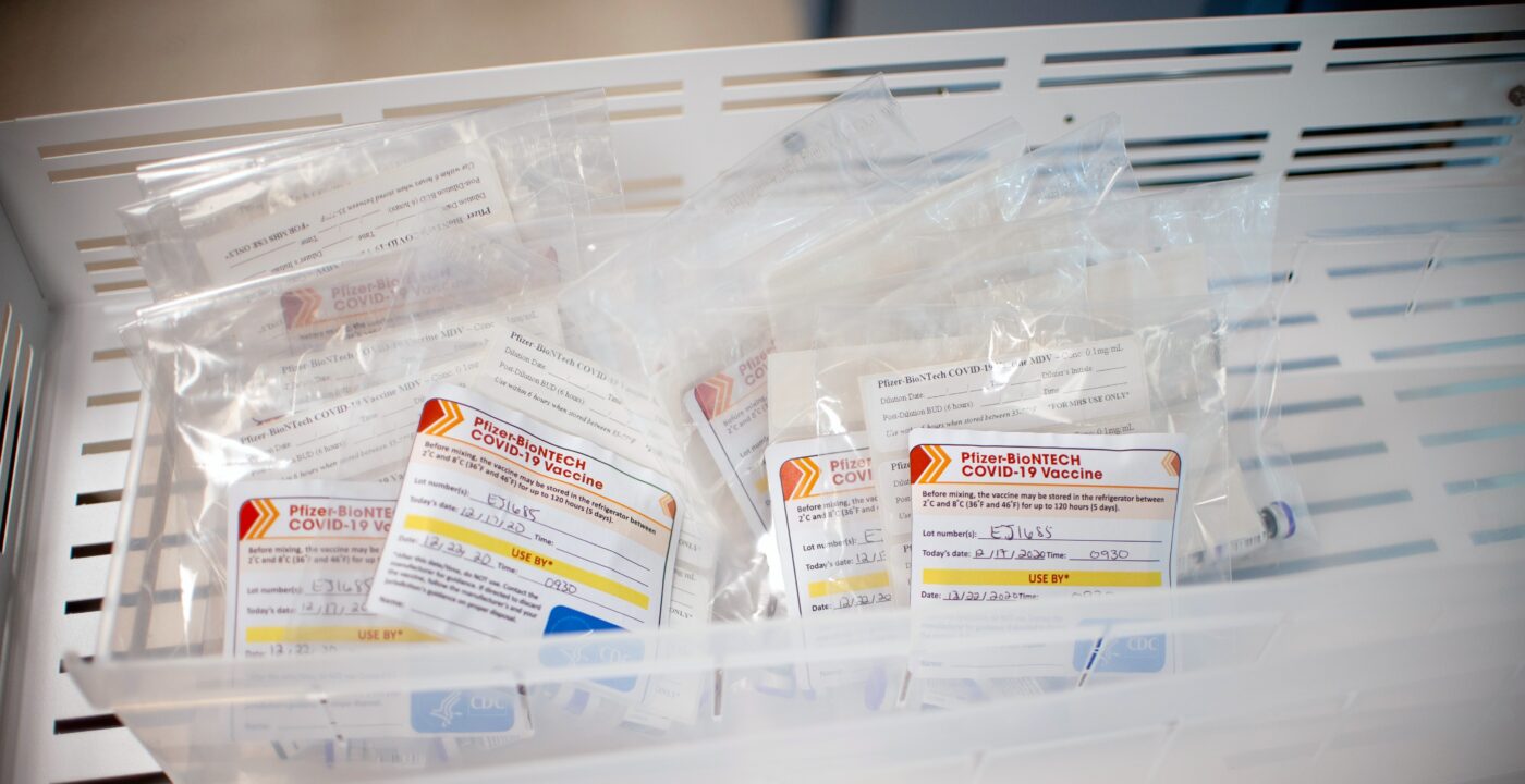 Bin full of COVID-19 booster shots