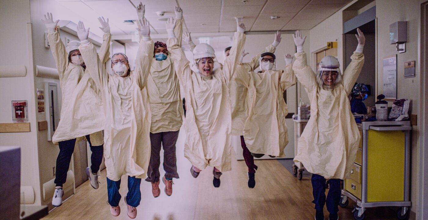Health care workers jumping for joy