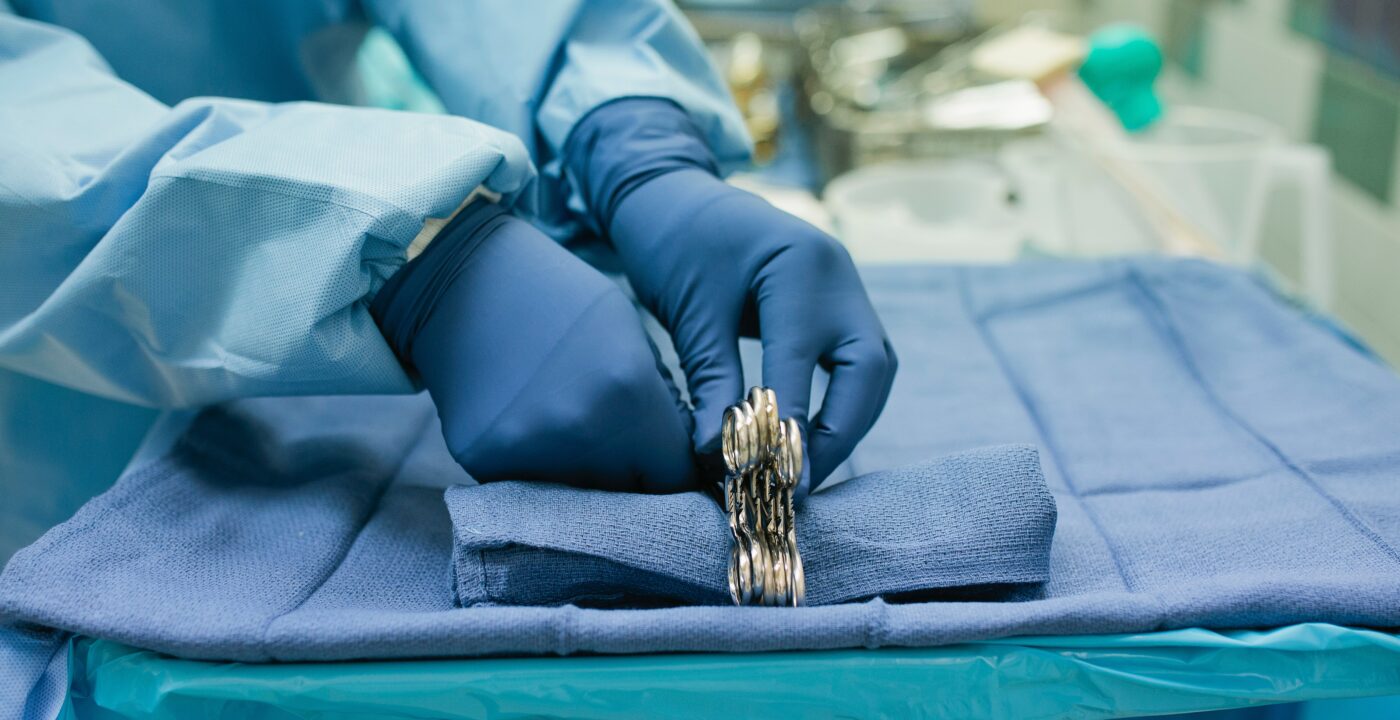 Surgeon hands grabbing tools