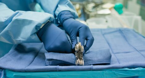 Surgeon hands grabbing tools