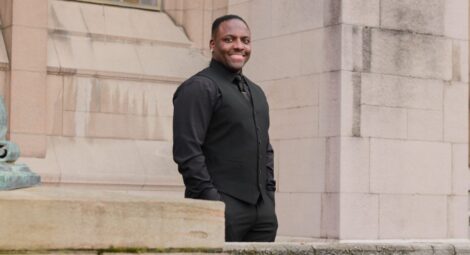 Man standing on the steps smiling