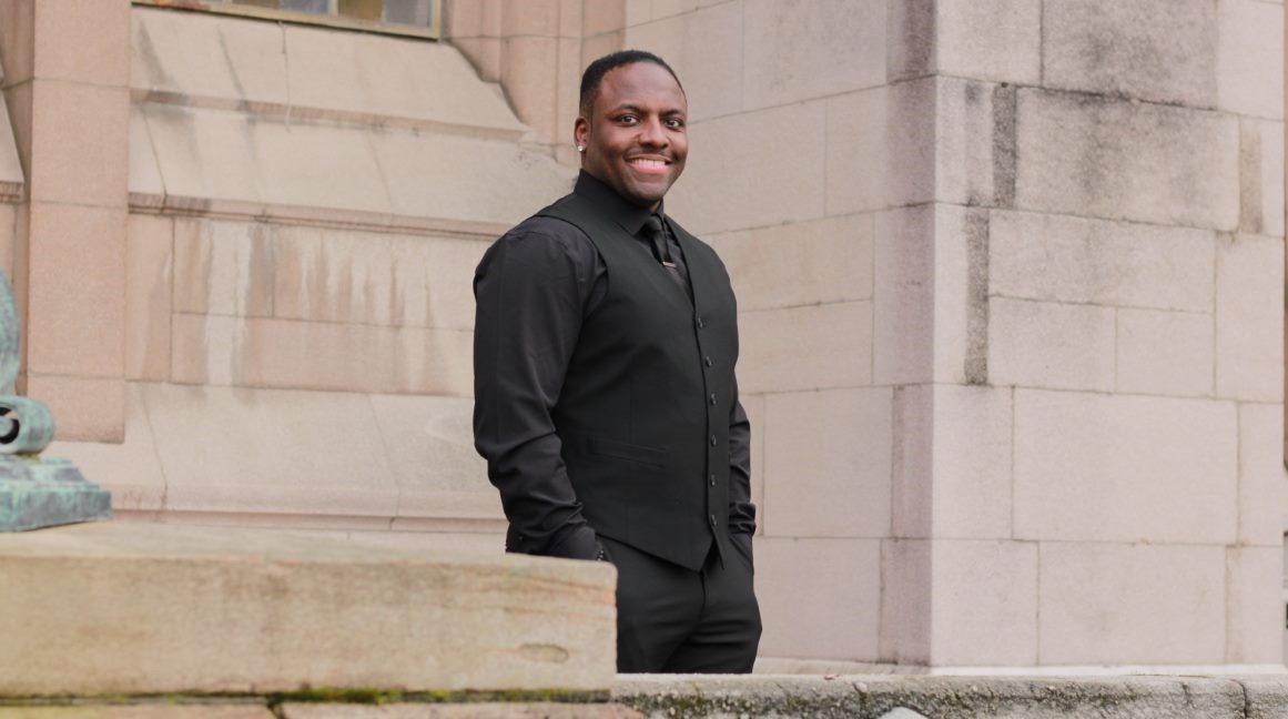 Man standing on the steps smiling