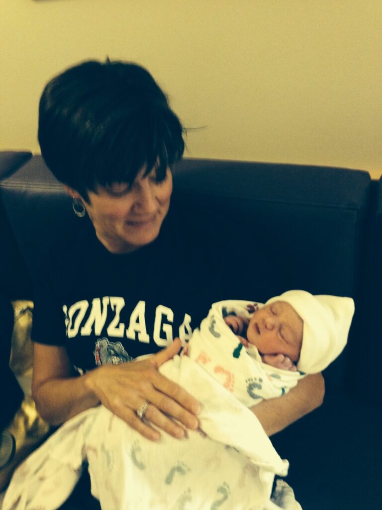 Older photo of a woman holding a baby