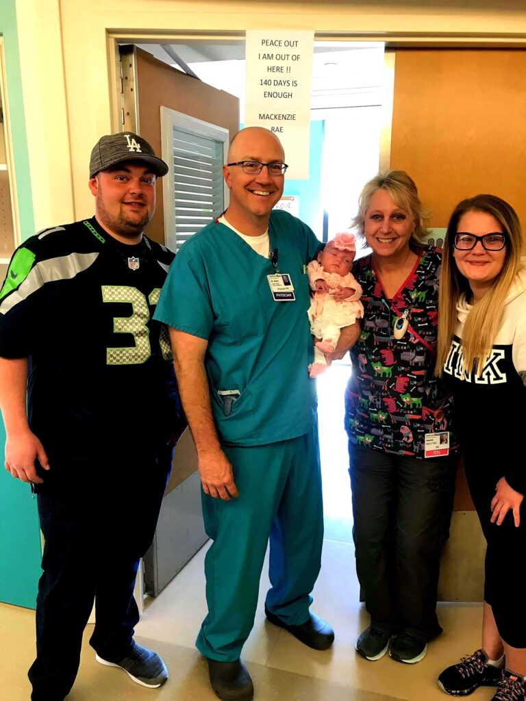 Medical professional and family posing