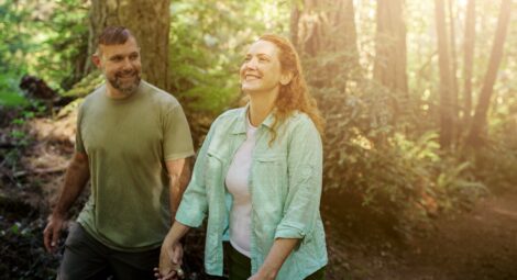 Couple walking through forest