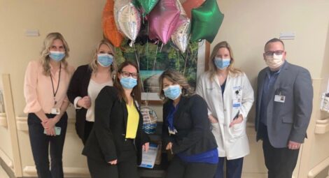 Staff posing for camera with balloons