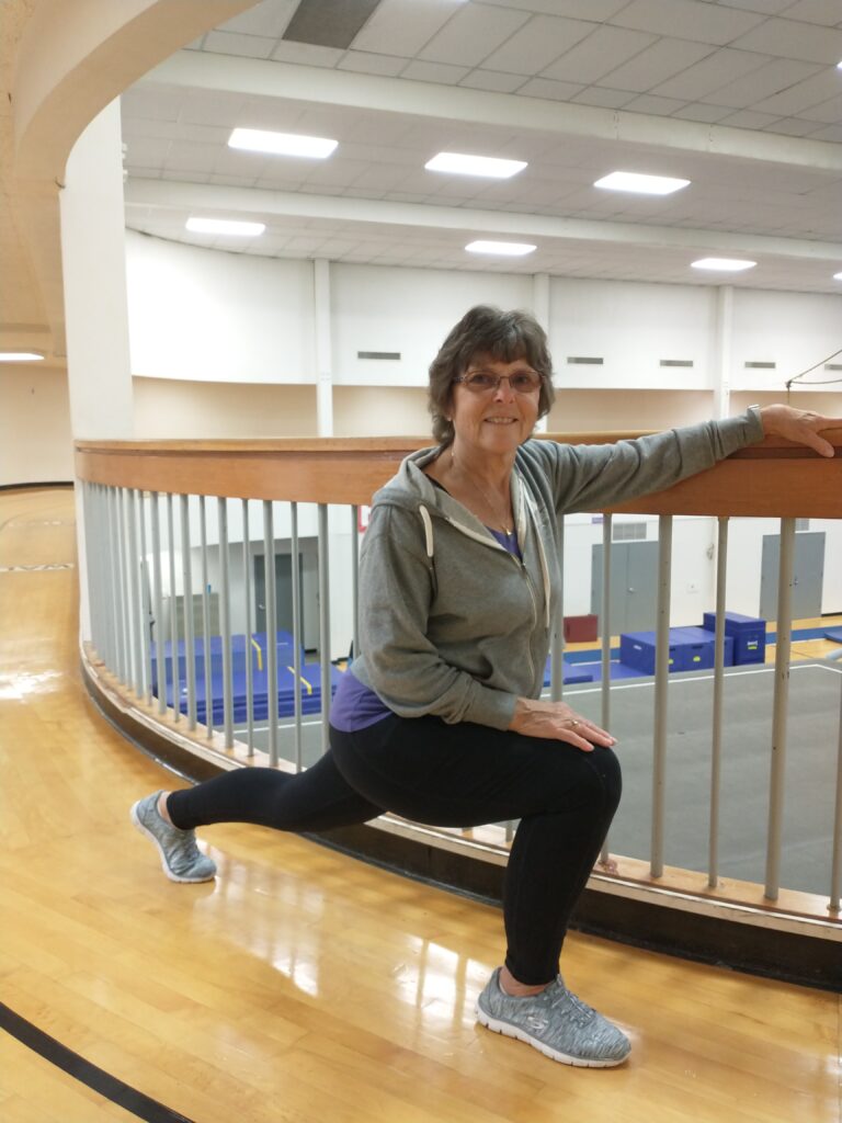 Woman stretching on an indoor track