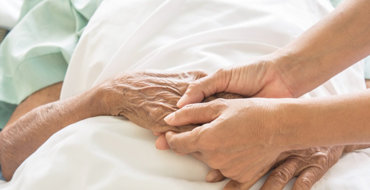 Holding hands in a hospital bed